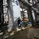 Sudanese and Chinese workers install machines at the White Nile Sugar Factory in El Diwaym March 3, 2012.